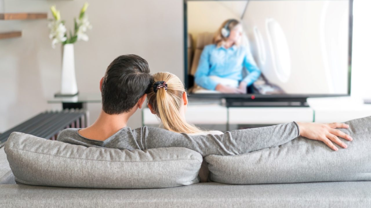 Loving couple watching tv at home